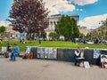 Street artists drawing portraits of tourists on canvas for money in independence square in Kiev