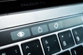 Kiev, Ukraine - August 9,2022: Button symbolizing file upload and sharing on touch bar apple macbook pro close up. Additional