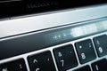 Kiev, Ukraine - August 9, 2022: Glitched screen brightness adjustment slider on touch bar apple macbook pro closeup