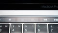 Kiev, Ukraine - August 9,2022: Keyboard backlight brightness adjustment touch buttons on touch bar apple macbook pro close up.