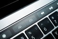 Kiev, Ukraine - August 9,2022: Keyboard backlight brightness buttons on touch bar apple macbook pro close up. Additional small