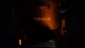 Kiev, Ukraine - August 14, 2021: Logo of the three-axis stabilizer Ronin 2 close-up in a beam of warm light. Off button
