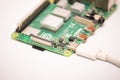 Kiev, Ukraine - August 13th, 2020: Close-up of a powered Raspberry Pi 4 Model-B on a white background. The RPI4 is a credit-card-