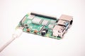 Kiev, UkrainPowered by USB-C cord single-board microcomputer RPI4. Blurred Raspberry Pi logo