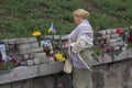 Kiev, Ukraine - August 24, 2016: Woman, flowers at the monument of the sky hundreds of dead during the revolution