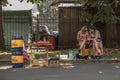 KIEV, UKRAINE - AUGUST 9, 2015: Young girls selling Kvass a popular Eastern European drink checking their smartphone on a street Royalty Free Stock Photo