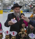 02.09.2019 Kiev, Ukraine. the chief rabbi of the city of Kiev lights candles with children at the festival of Hanukkah