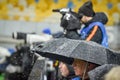 KIEV, UKRAINE - December 12, 2018: Journalists photographers are protected from snow during the UEFA Champions League match