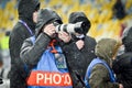 KIEV, UKRAINE - December 12, 2018: Photographer and journalist working with the camera during the UEFA Champions League match