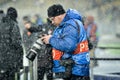 KIEV, UKRAINE - December 12, 2018: Photographer and journalist working with the camera viewing pictures during the UEFA Champions