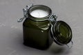 KIEV, UKRAINE - DECEMBER 11, 2020: Small scented candle in a green glass candlestick with a tight lid.