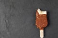 KIEV, UKRAINE - December 24, 2020: Ice cream stick with brittle nuts and haagen dazs salted caramel, covered with chocolate. Ice