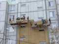 Kiev, Ukraine, Europe - October 2019: Facade work. Workers insulate the facade of a residential building. High-altitude work.