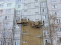 Kiev, Ukraine, Europe - October 2019: Facade work. Workers insulate the facade of a residential building. High-altitude work.