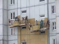 Kiev, Ukraine, Europe - October 2019: Facade work. Workers insulate the facade of a residential building. High-altitude work.