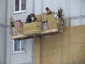 Kiev, Ukraine, Europe - October 2019: Facade work. Workers insulate the facade of a residential building. High-altitude work.