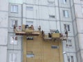 Kiev, Ukraine, Europe - October 2019: Facade work. Workers insulate the facade of a residential building. High-altitude work.