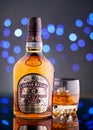 Kiev, Ukraine. February 04, 2018. A bottle of aged 12 year old Scotch whiskey Chivas Regal on a black reflective surface