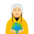 Kiev, Ukraine February 4, 2020: Greta Thunberg in a yellow cloak holds the planet Earth in her hands