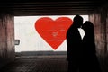 Kiev, Ukraine -February 14, 2018. Valentine's Day. Editorial. A couple silhouette kissing against the painted red Royalty Free Stock Photo