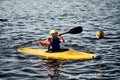 Kiev, Ukraine, 10.06.2020: A guy wearing a helmet on a canoe polo rowing a paddle and sailing on water. canupolo. puts on a rescue