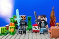 Minifigure Iron man with diamond sword and Characters of the game Minecraft run away from the Creeper