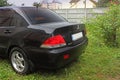 Kiev, Ukraine; January 20, 2014. Mitsubishi Lancer back, Japanese car on a green background Royalty Free Stock Photo