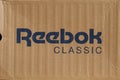 KIEV, UKRAINE-JULY 19,2017: blue Reebok sign with light brown background, Reebok International Ltd. - Sports shoe and sewing compa Royalty Free Stock Photo