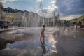 Kiev, Ukraine - July 13, 2018: Children bathe in the fountain on the Poshtova square