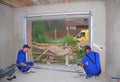 KIEV, UKRAINE - JULY 13, 2016: Contractors Installing Garage Door.