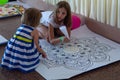 Kiev, Ukraine - July 30, 2017: Girls make a mandala from colored sand