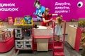 Kiev, Ukraine, July 4 2020, Little customer at cashier desk buys toys at toy store, caucasian woman cashier helps little
