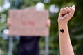 Kiev, Ukraine - July 31 2020: raised fist with black heart on poster Racism is the pandemic background. Stop racism Royalty Free Stock Photo