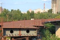 Unfinished part of the bridge over the river. Rusty metal structure of the bridge