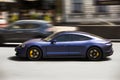 Kiev, Ukraine - June 12, 2021: Blue electric Porsche Taycan in the city. Porsche in motion