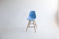 Kiev, Ukraine - June 10, 2019: Blue wooden chairs for the legs on a white background. White cyclorama in the studio