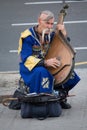 Kiev, Ukraine - June 19, 2016: Elderly kobzar in a national costume plays a kobza Royalty Free Stock Photo