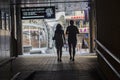 Kiev, Ukraine - June 18, 2016: Silhouettes of young couples passing through a tunnel