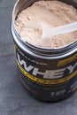 KIEV, UKRAINE - June 06, 2020: Whey protein in a jar. Sports supplements for bodybuilding: a can of whey protein with a taste of c