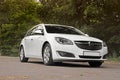 Kiev, Ukraine - June 19, 2018: White Opel Insignia on the road in a beautiful forest