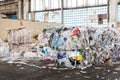 Kiev, Ukraine - March 06.2020: Pile of used paper wrap and document against bales of compressed cardboard collected for