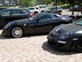 Kiev, Ukraine - May 14, 2011: Black supercars Ferrari 599 GTB Fiorano and Porsche 911 Turbo Gemballa Avalanche GTR 800 EVO-R in
