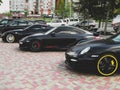 Kiev, Ukraine - May 14, 2011: Black supercars Ferrari 599 GTB Fiorano and Porsche 911 Turbo Gemballa Avalanche GTR 800 EVO-R and