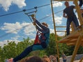 Brave girl having fun on zipline over Dnieper river in Kiev Royalty Free Stock Photo