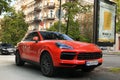 Kiev, Ukraine - May 22, 2021: Bright orange German Porsche Cayenne car parked in the city Royalty Free Stock Photo