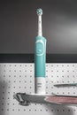 KIEV, UKRAINE - MAY 09, 2021: Electric toothbrush Oral-B Vitality Sensitive wooden background in bathroom. Royalty Free Stock Photo