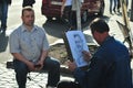 Man drawing another man caricature on the street of Kiev. Royalty Free Stock Photo