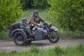 Kiev, Ukraine - May 09, 2019: Men in the clothes of German soldiers on a motorcycle at the historic reconstruction