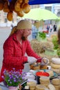 KIEV, UKRAINE - MAY 19, 2018: The seller of cheese at the traditional street fair of a variety of natural organic products