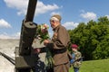 Kiev, Ukraine - May 09, 2016: Veteran lays flowers at the gun